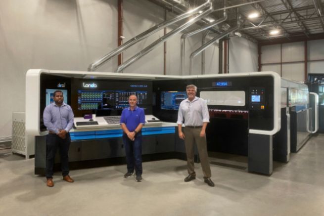 From L to R, the director of sheet operations, the vice-president of purchasing and Mr. Duggal, CEO Duggal, in front of the Landa S10.